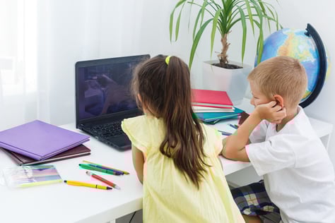 Primary age children using a laptop
